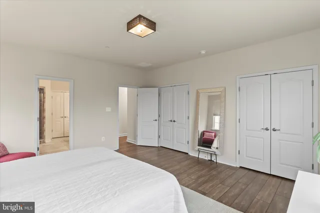 a spacious bathroom with double sink and shower