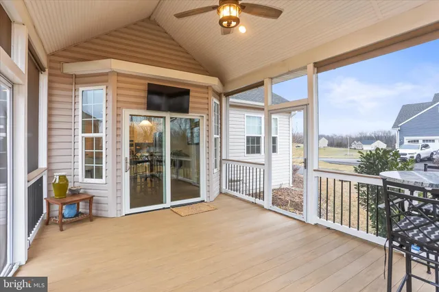 a view of a chairs on wooden deck and lake