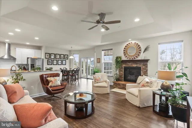 a living room with furniture a fireplace and a chandelier