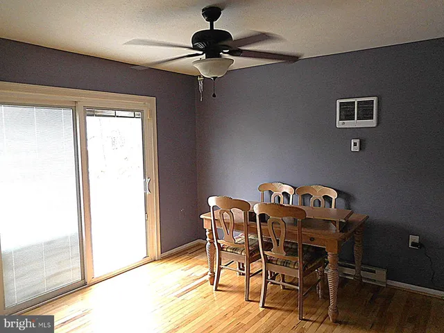 a view of a dining room with furniture chandelier and wooden floor