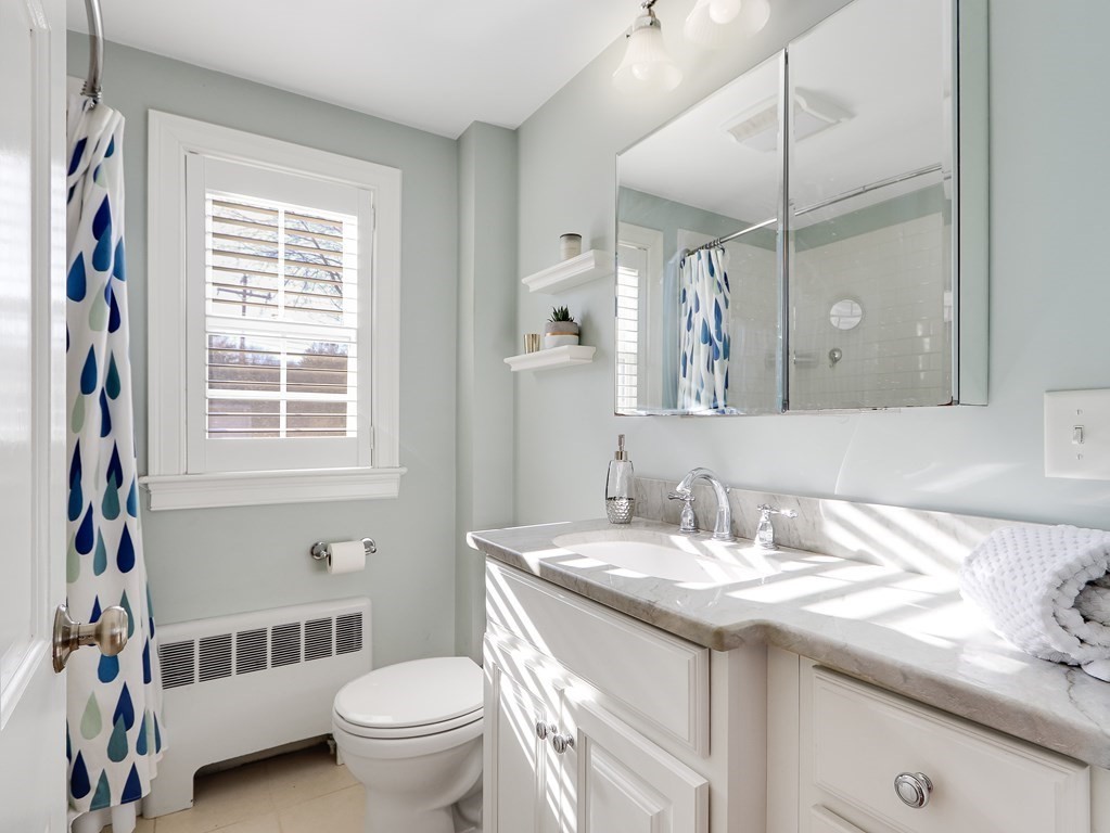 2 Central Terrace Needham, MA 02494 - Photo 14 of 33 a bathroom with a granite countertop toilet a sink a mirror a and a window