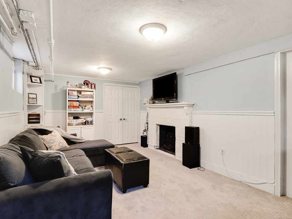 2 Central Terrace Needham, MA 02494 - Photo 20 of 33 a living room with furniture a fireplace and a flat screen tv