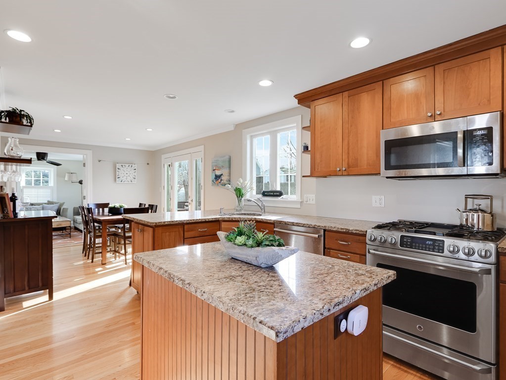 2 Central Terrace Needham, MA 02494 - Photo 10 of 33 a kitchen with stainless steel appliances granite countertop a kitchen island hardwood floor sink stove and granite counter top