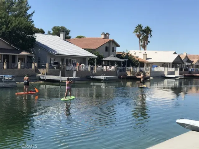 a view of a lake with a house and a big yard