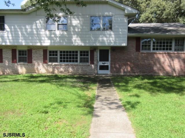 2423 Cedar Bridge Road Northfield, NJ 08225 - Photo 1 of 1 a front view of a house with garden