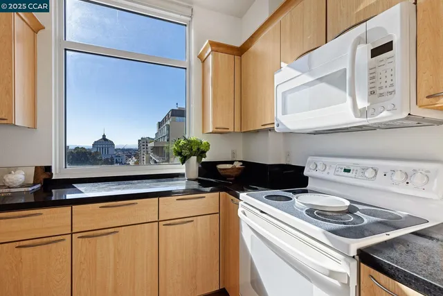 a kitchen with a stove and a white cabinets