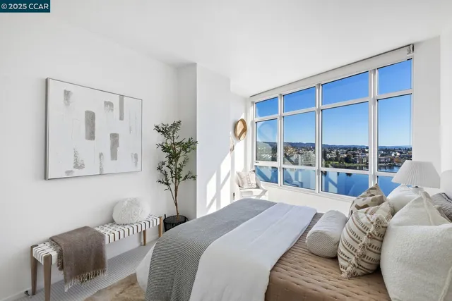 a bedroom with a large bed and a window