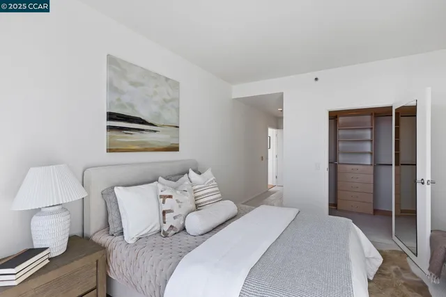 a bedroom with a bed and a lamp