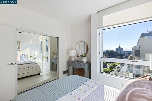 a bedroom with a bed and a painting on the wall