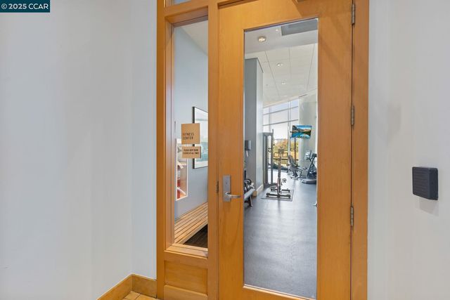 a view of hallway with livingroom and wooden floor