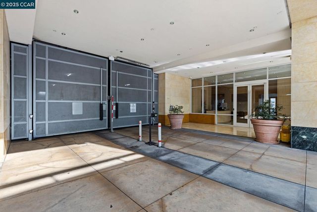 a view of a house with a large window and wooden fence