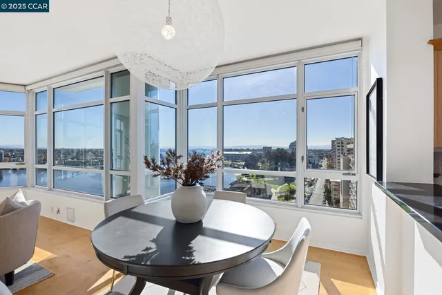 a dining room with furniture a chandelier and wooden floor