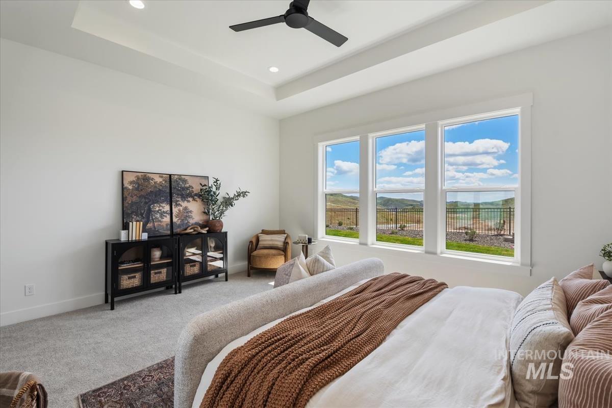 7615 Brown Way Eagle, ID 83714 - Photo 26 of 43 Spacious room featuring a tray ceiling with recessed lighting, a ceiling fan, and carpeted flooring