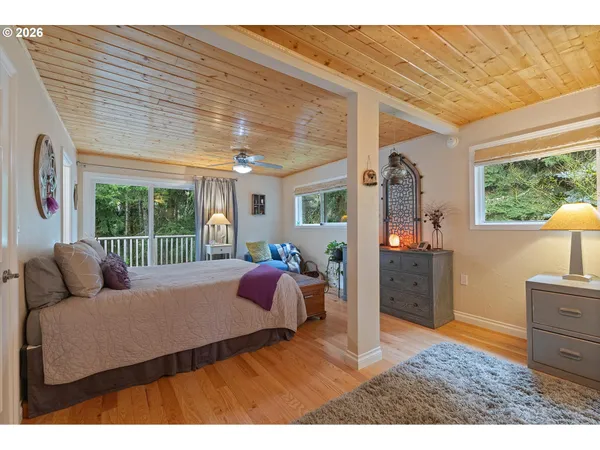 a bedroom with furniture and a large window