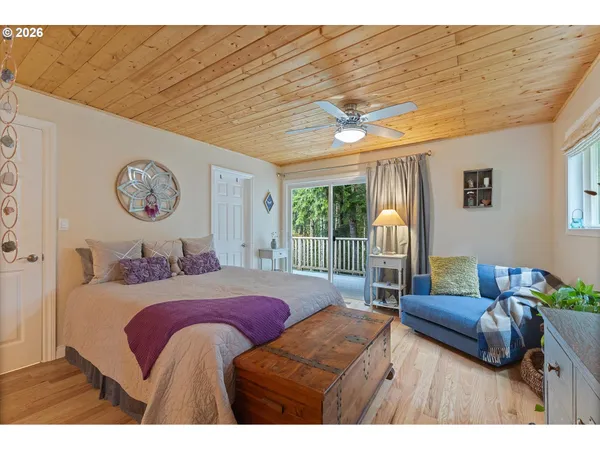 a bedroom with furniture and a large window