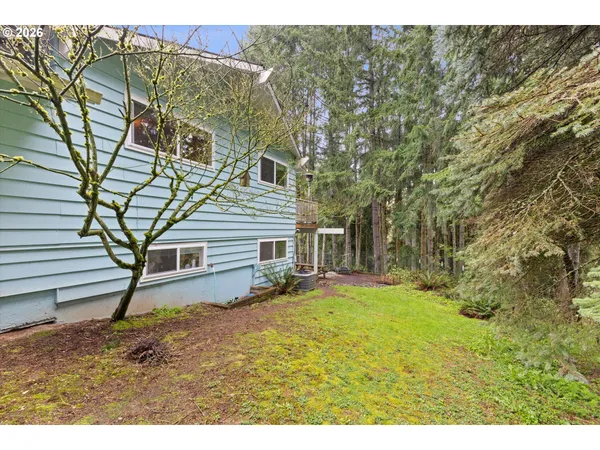 a view of a house with backyard porch and sitting area