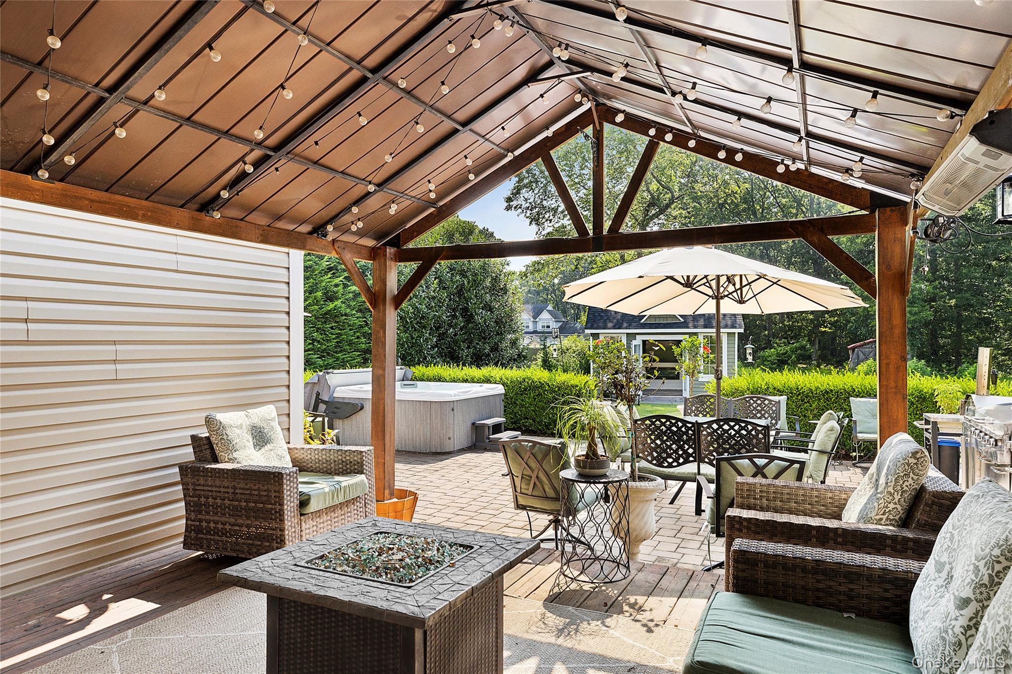 46 South Howell Avenue Centereach, NY 11720 - Photo 14 of 19 a view of a patio with a table and chairs under an umbrella