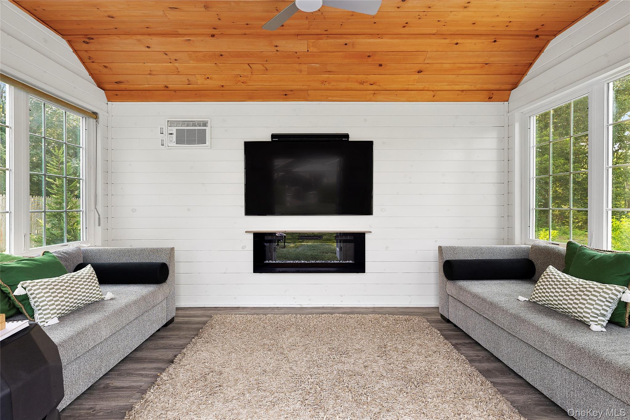 46 South Howell Avenue Centereach, NY 11720 - Photo 17 of 19 a living room with couches and a flat screen tv