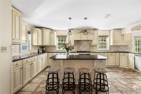 a kitchen with granite countertop white cabinets and white appliances
