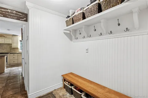 a view of entryway with wooden floor and windows