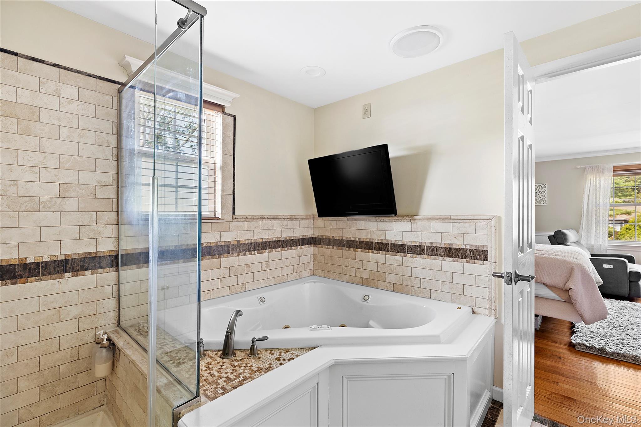 46 South Howell Avenue Centereach, NY 11720 - Photo 9 of 19 a bathroom with a tub sink and mirror