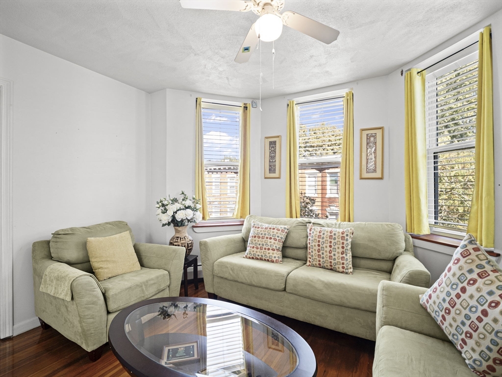 95 Florida Street, Unit 2 Boston, MA 02124 - Photo 2 of 29 a living room with furniture and a large window