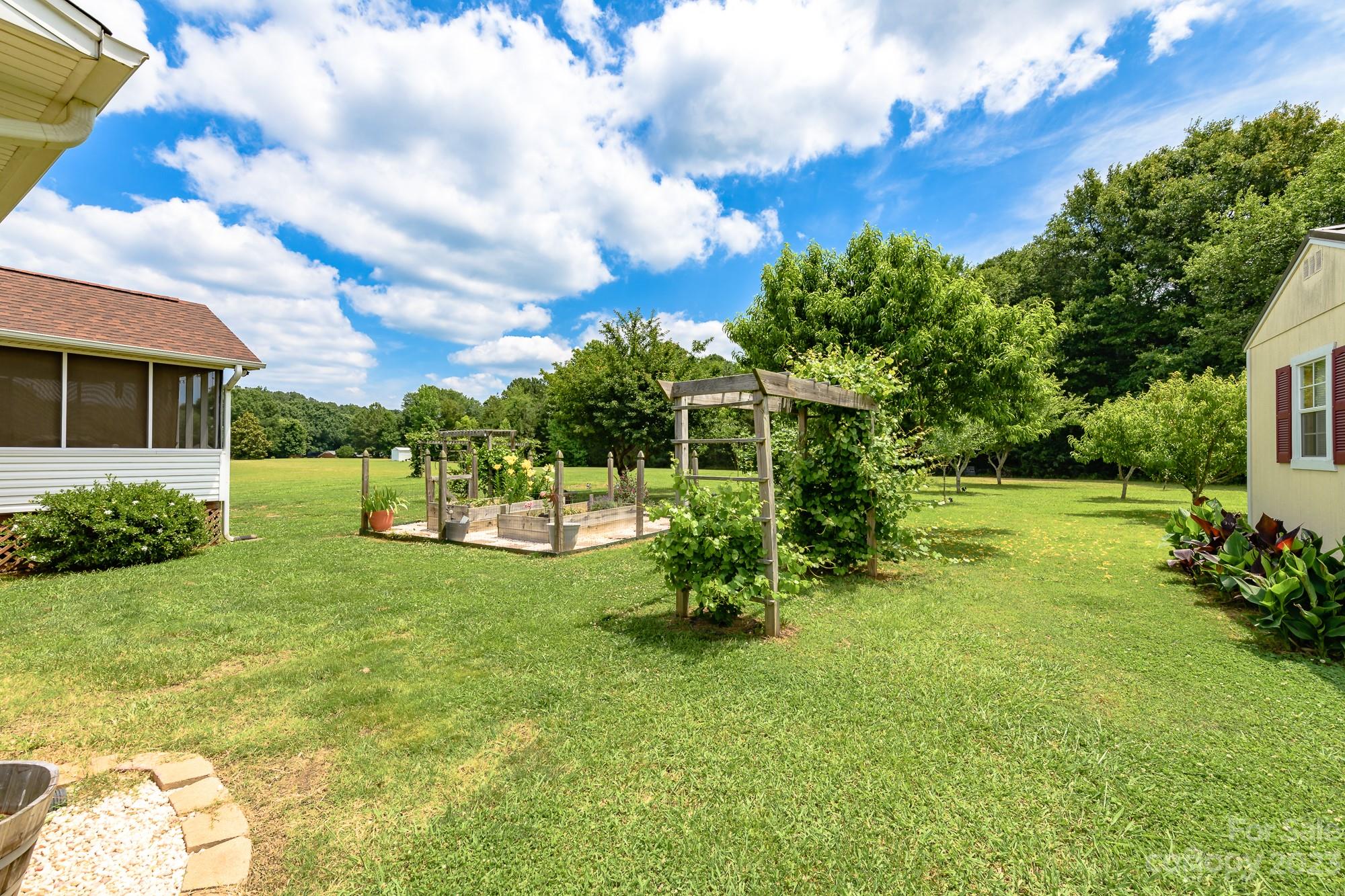 244 Pennington Road Rock Hill, SC 29732 - Photo 5 of 20 a view of a garden with a bench in the garden