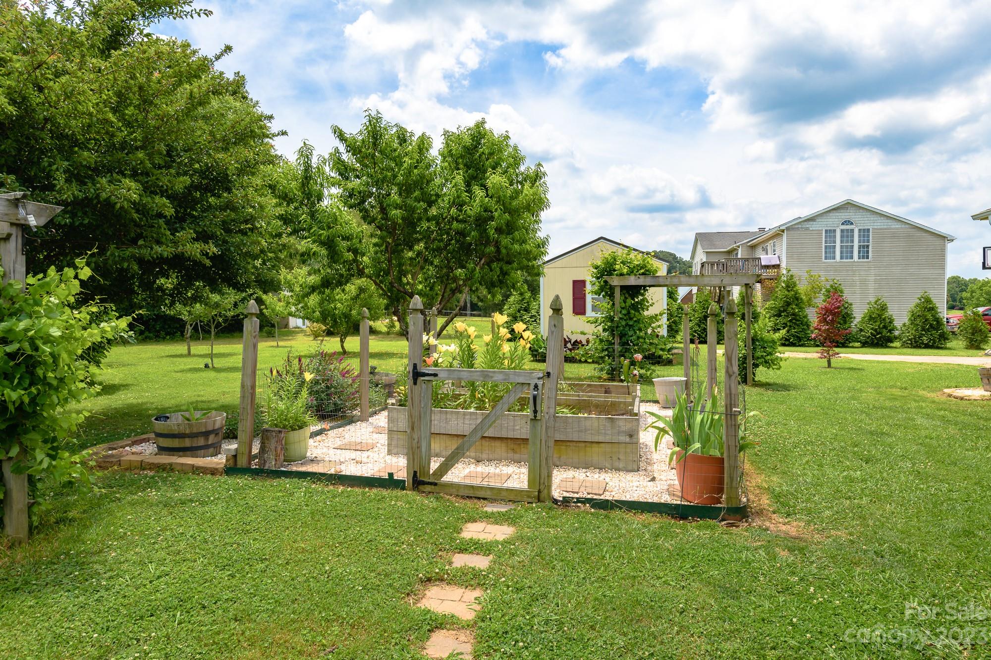 244 Pennington Road Rock Hill, SC 29732 - Photo 8 of 20 a view of a garden with a house in the background