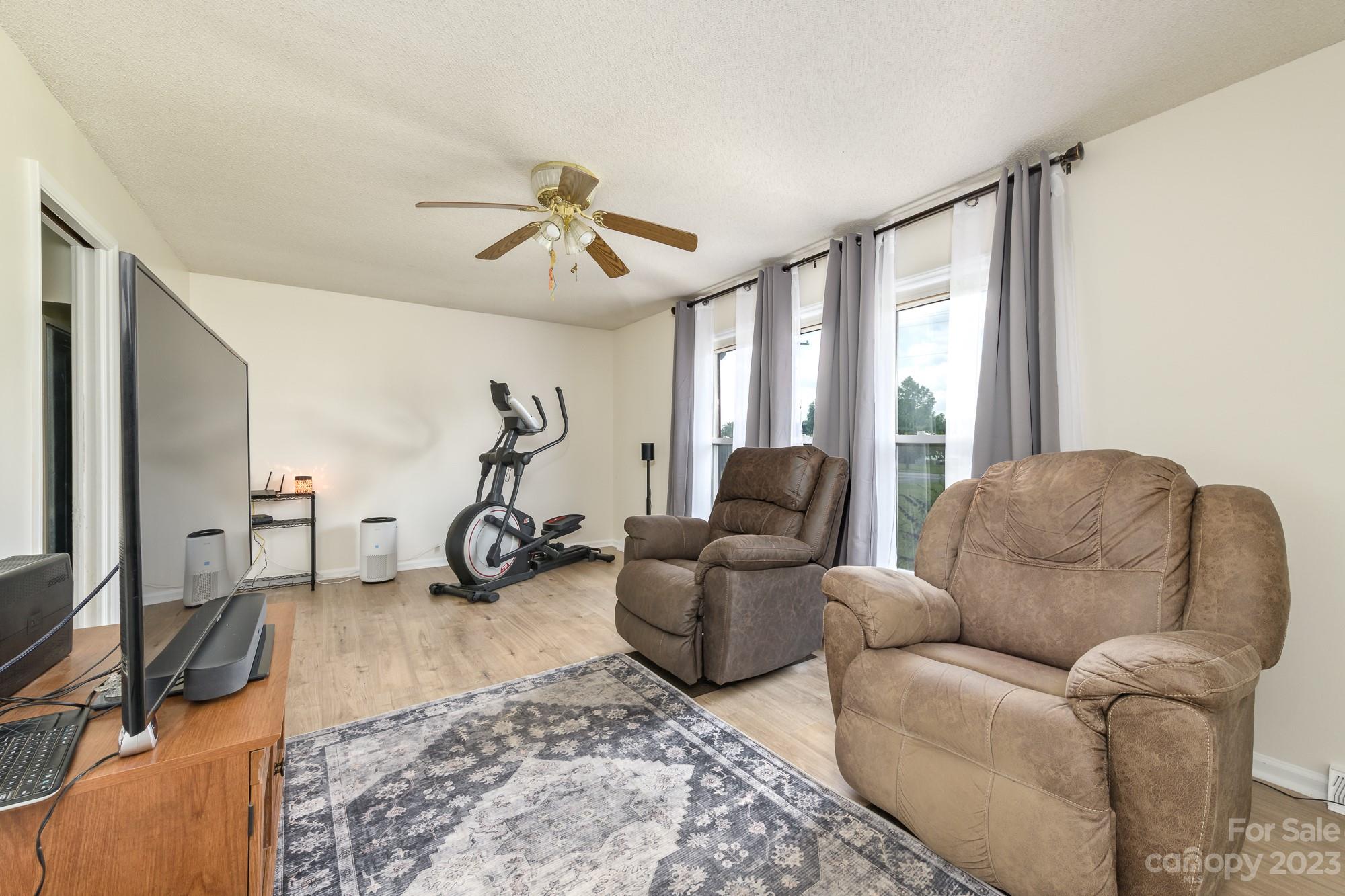 244 Pennington Road Rock Hill, SC 29732 - Photo 9 of 20 a living room with furniture a large window and gym equipment