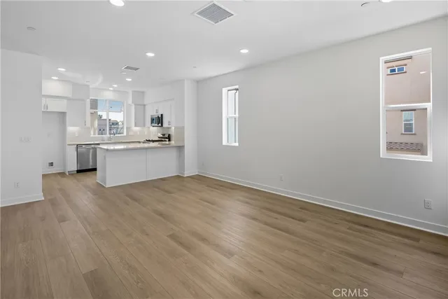 a view of kitchen with wooden floor and electronic appliances