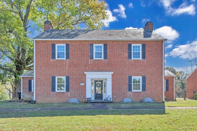 a view of a house with a yard and a large window
