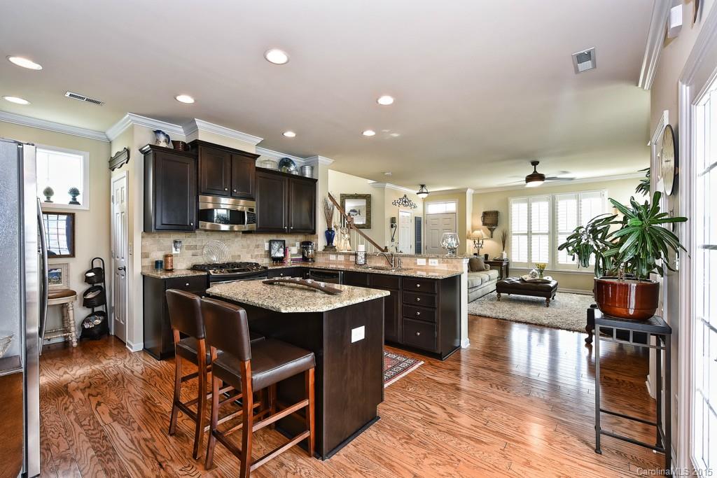 3446 Richard's Crossing Fort Mill, SC 29708 - Photo 4 of 15 a kitchen with kitchen island a counter top space a sink stainless steel appliances and cabinets