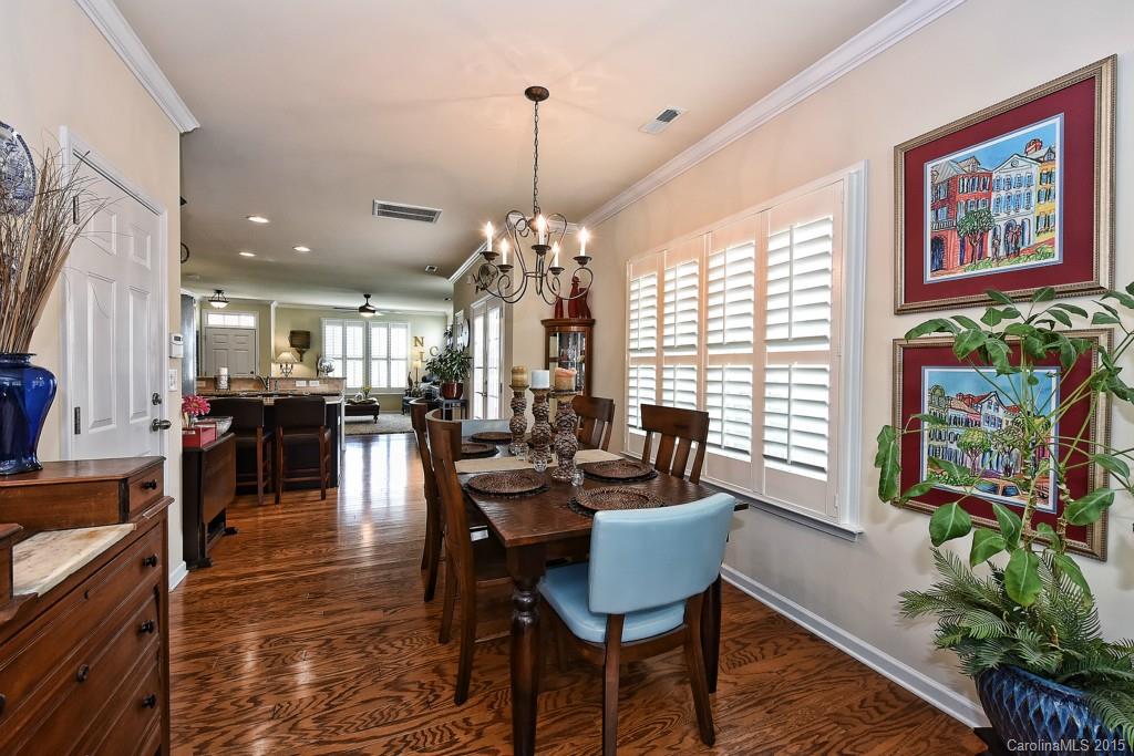 3446 Richard's Crossing Fort Mill, SC 29708 - Photo 9 of 15 a dining room with wooden floor a chandelier a wooden table and chairs