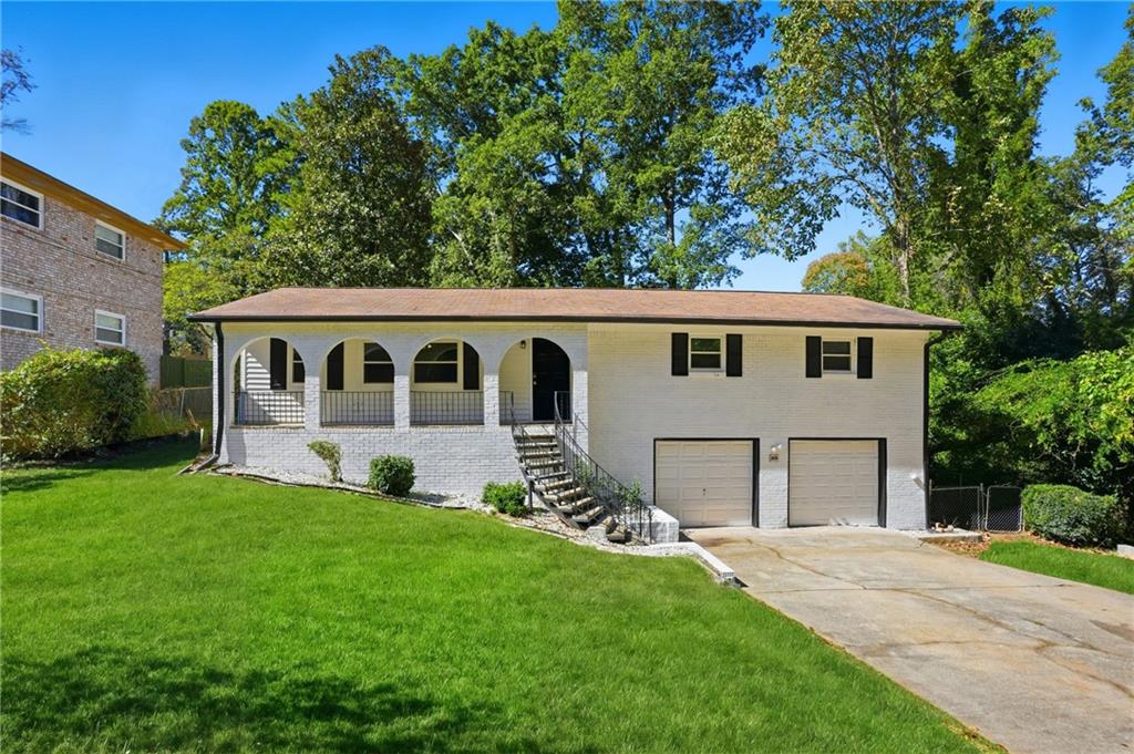 a view of house with backyard and garden