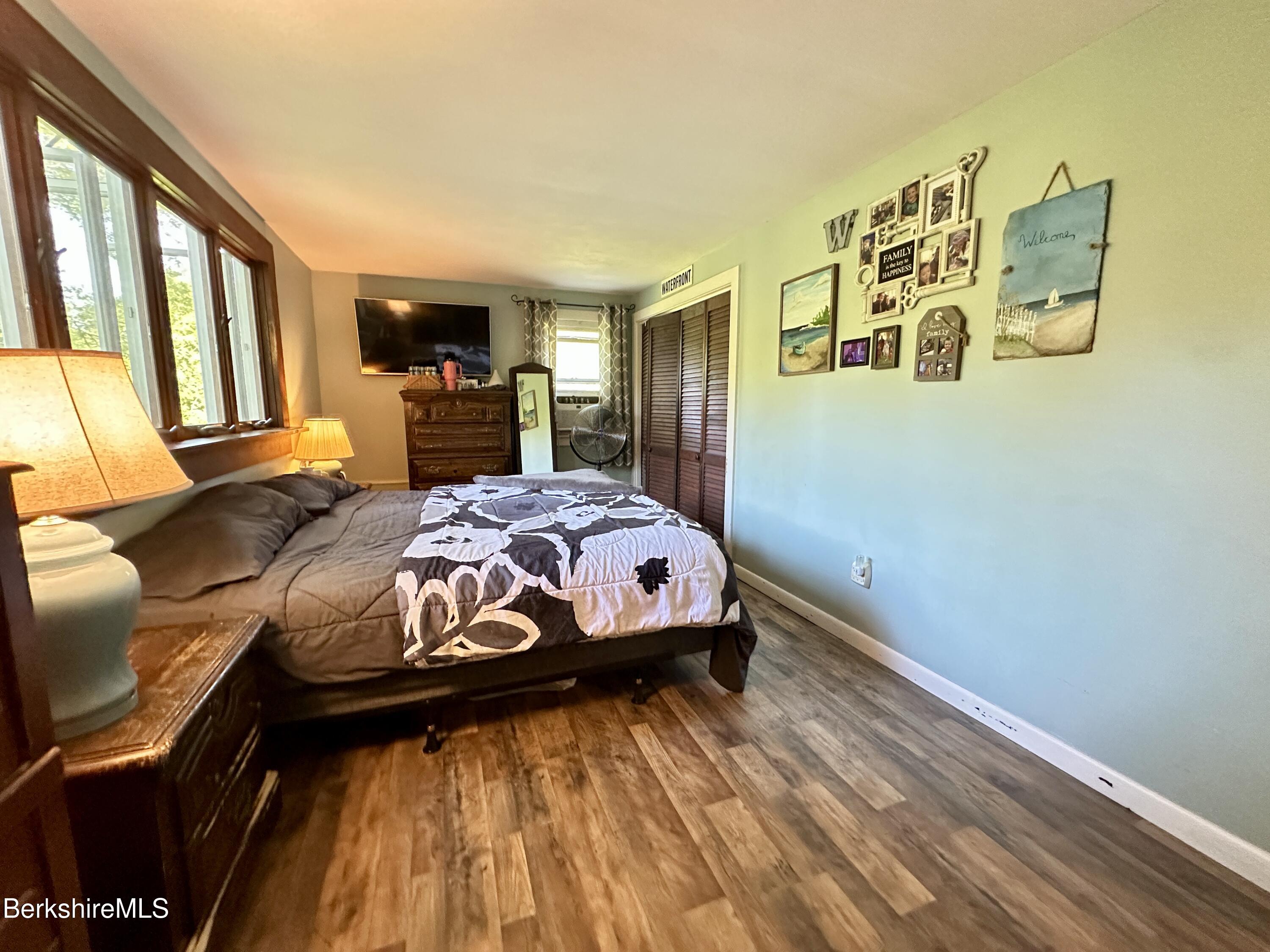 117 Norfolk Road New Marlborough, MA 01259 - Photo 12 of 16 a bedroom with a bed and wooden floor