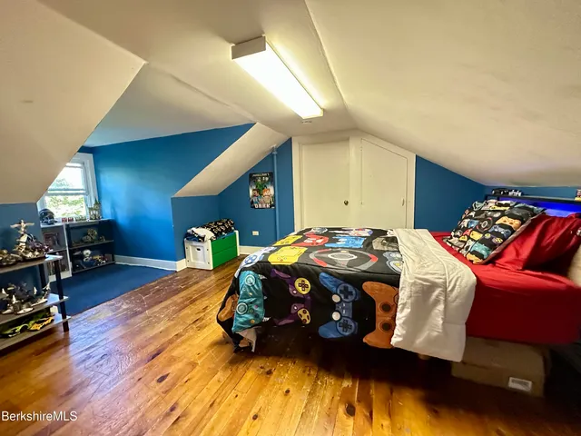 a bedroom with a bed and a lamp