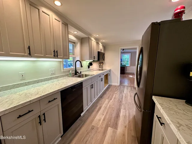 a kitchen with a sink stove and cabinets