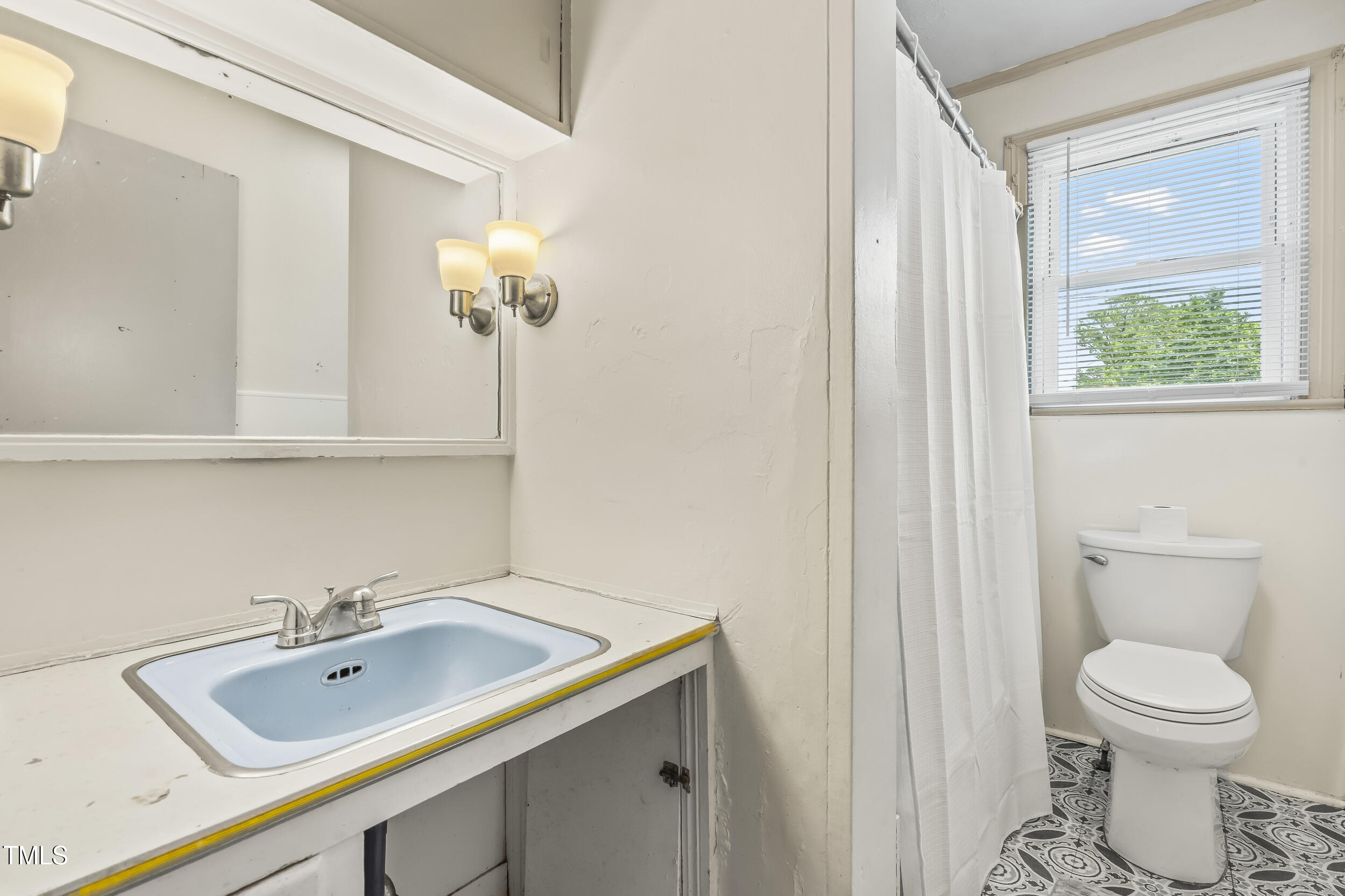 500 Rowan Road Clinton, NC 28328 - Photo 14 of 42 a bathroom with a sink a toilet and a mirror