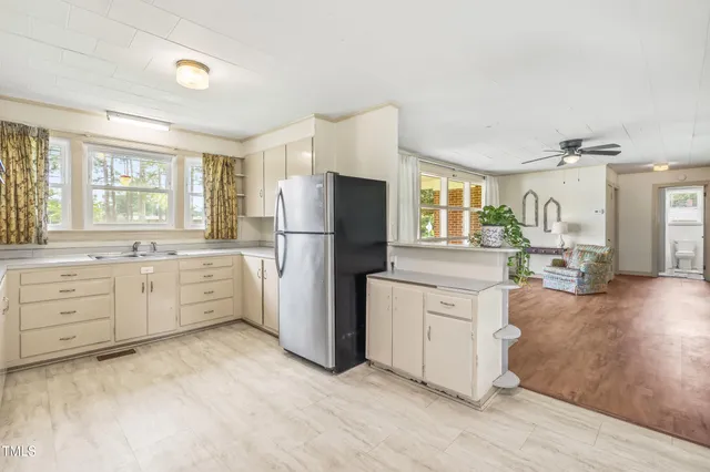 a kitchen with cabinets appliances and a window