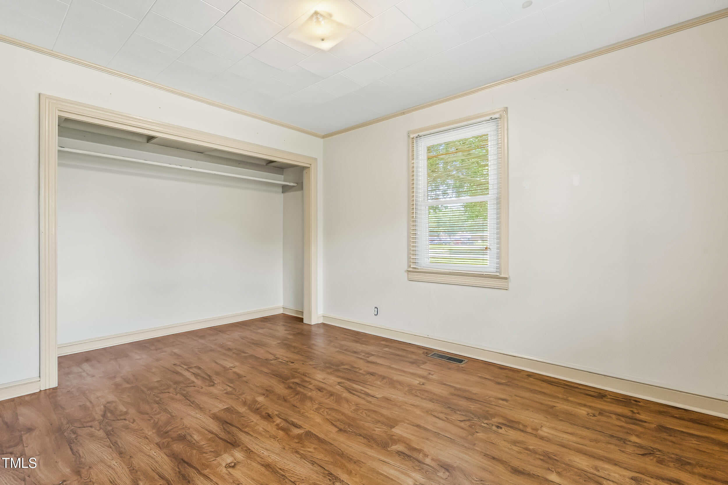 500 Rowan Road Clinton, NC 28328 - Photo 10 of 42 a view of an empty room with wooden floor and a window