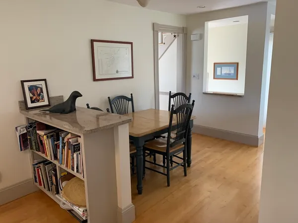a dining room with furniture and a window