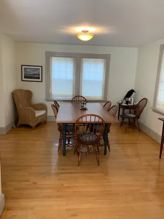 a view of a dining room with furniture and chandelier