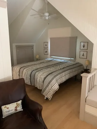 a bedroom with a bed and a ceiling fan