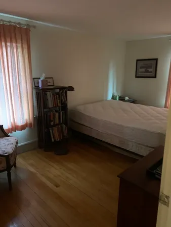 a bedroom with a bed a table and chair
