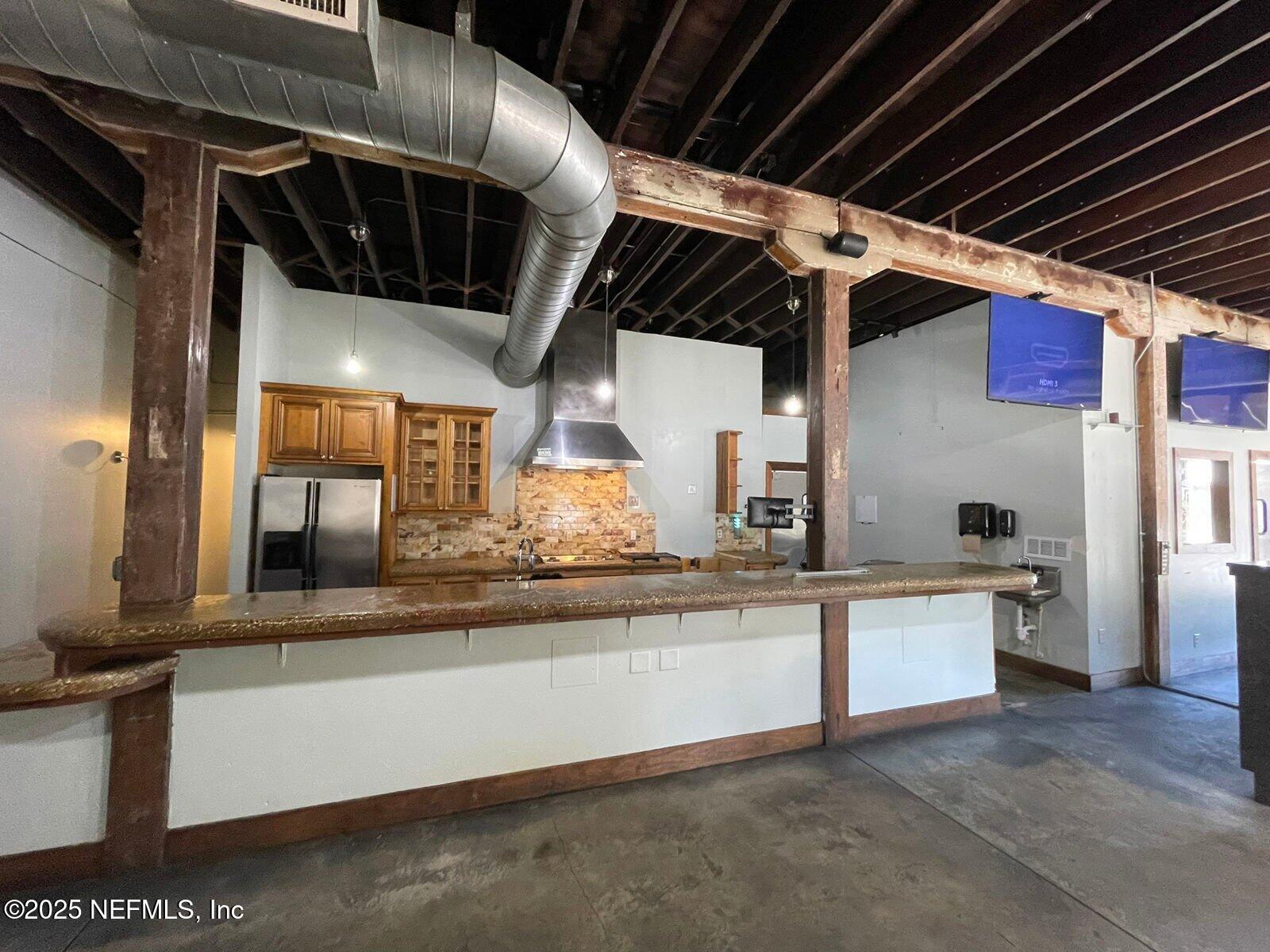 1602 Walnut Street Jacksonville, FL 32206 - Photo 5 of 10 a kitchen with stainless steel appliances granite countertop a sink a stove and a wooden floors