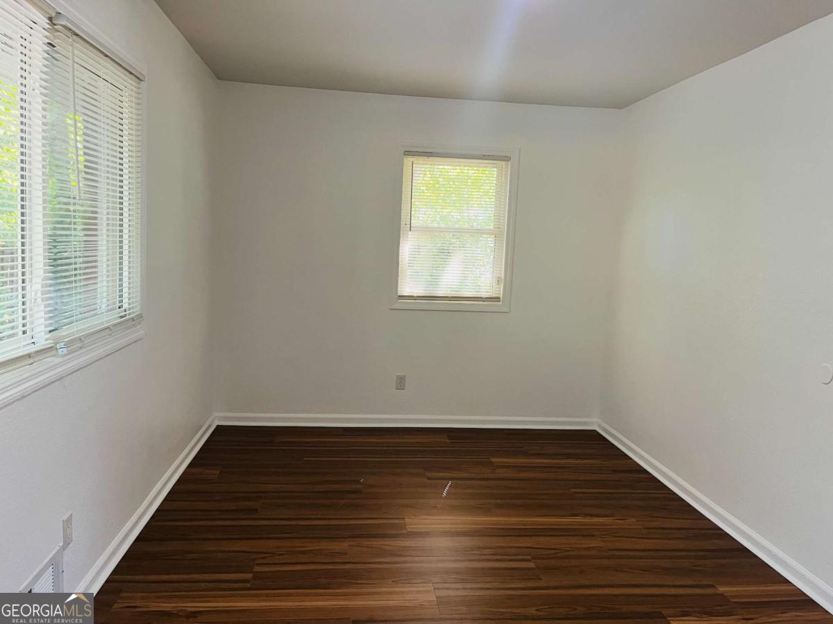 1076 Center Street Southwest, Unit 1074 Mableton, GA 30126 - Photo 12 of 26 a view of a room with wooden floors and window