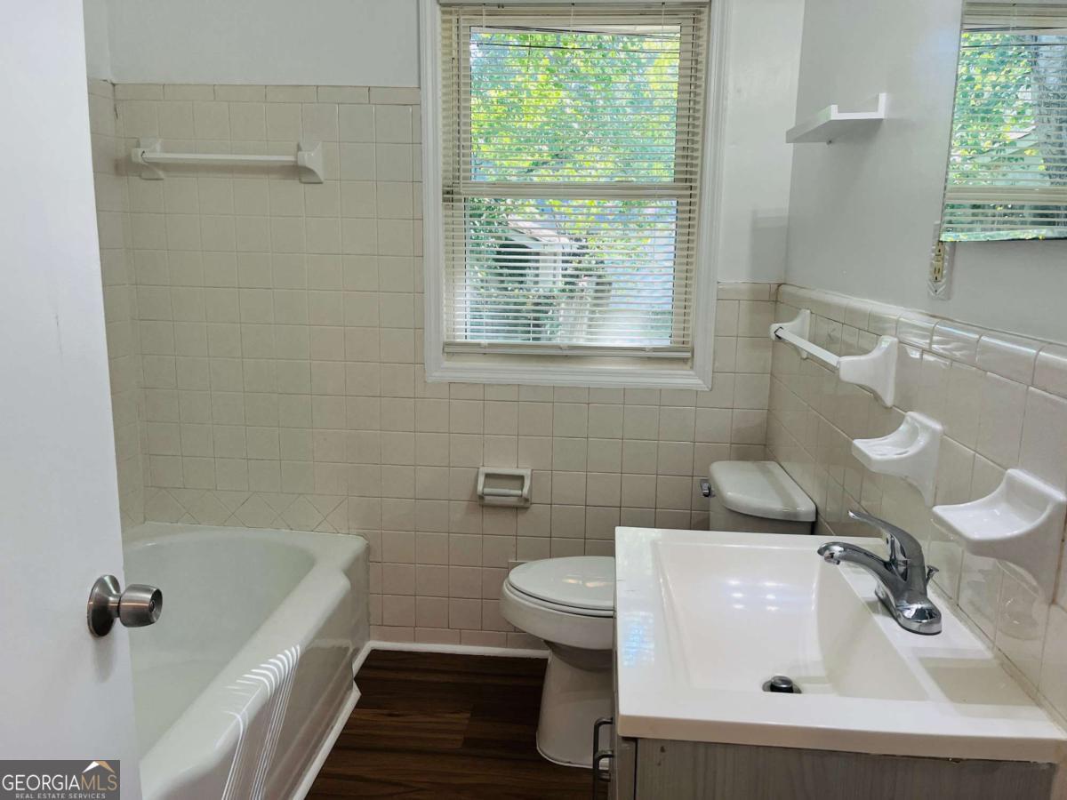1076 Center Street Southwest, Unit 1074 Mableton, GA 30126 - Photo 18 of 26 a bathroom with a sink a toilet and shower