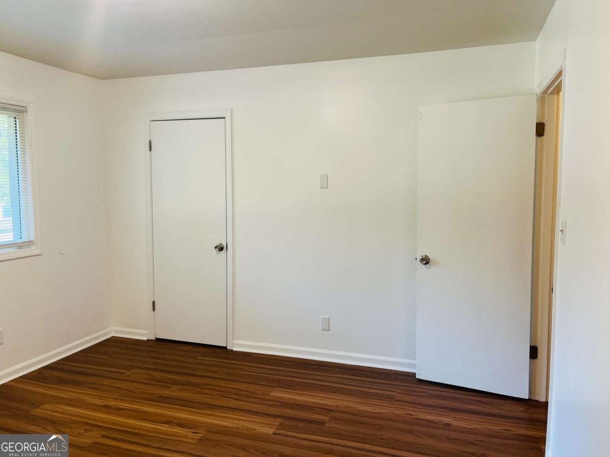 1076 Center Street Southwest, Unit 1074 Mableton, GA 30126 - Photo 24 of 26 a view of an empty room with wooden floor and closet