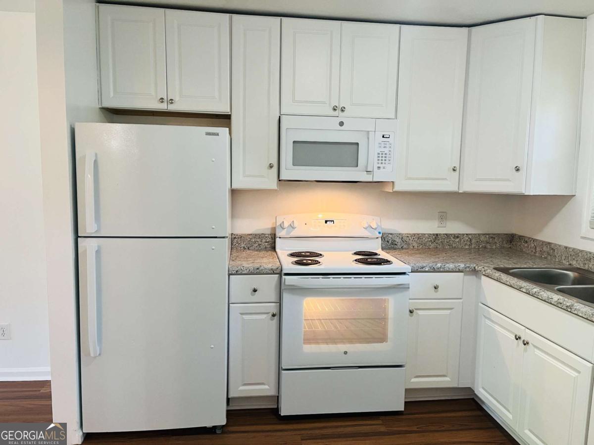 1076 Center Street Southwest, Unit 1074 Mableton, GA 30126 - Photo 8 of 26 a kitchen with white cabinets and white appliances