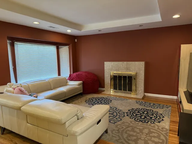 a living room with furniture a window and a fireplace